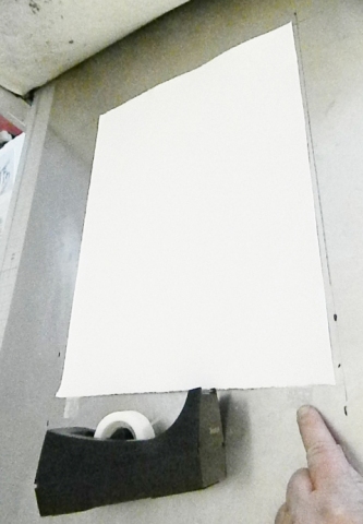 paper taped to press bed